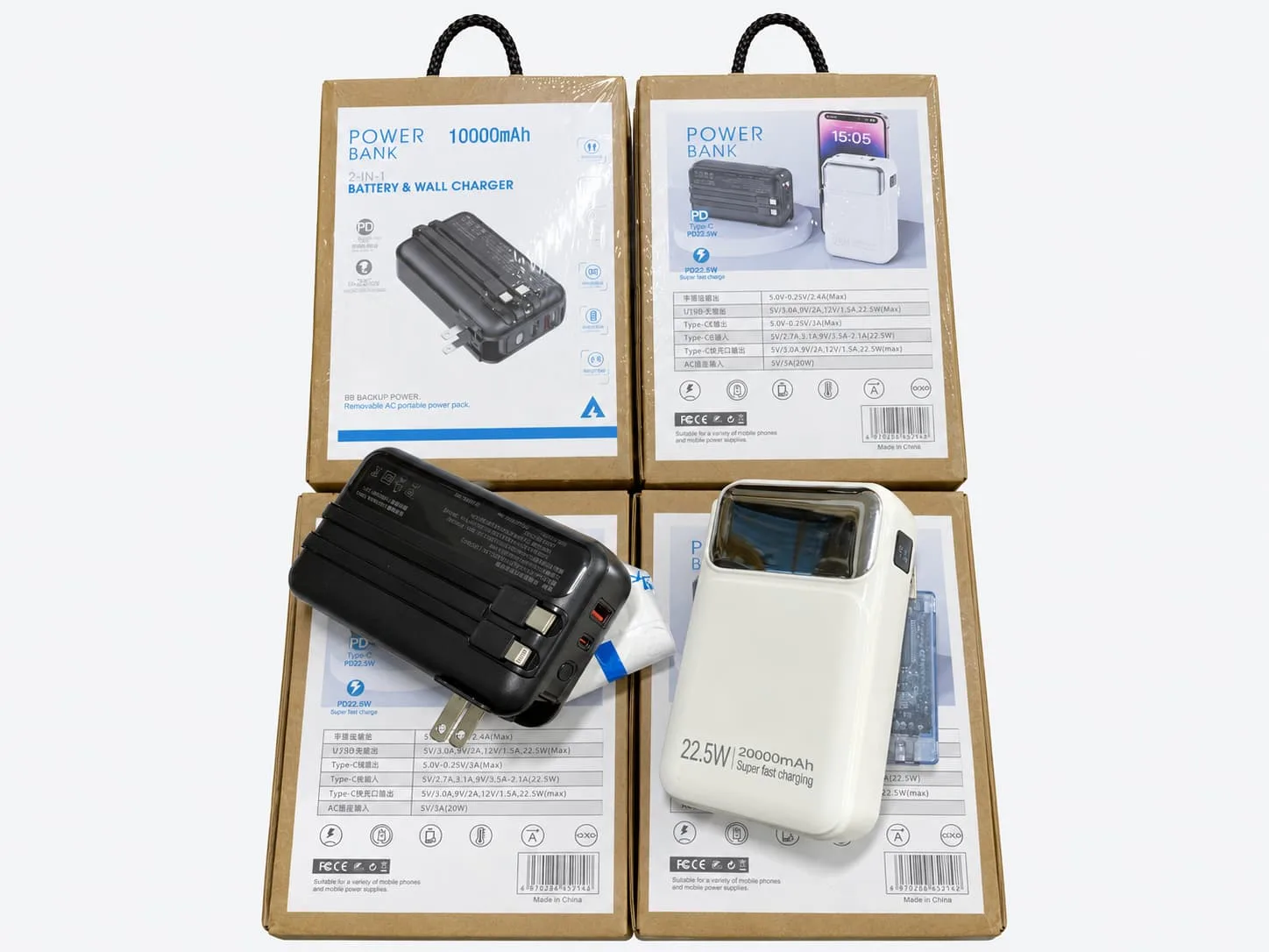 Kraft packaging with printed product labels and hanging handles shown with two power banks on a light gray background